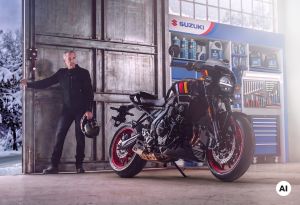 Mann mit Motorradhelm steht neben einem Suzuki-Motorrad in einer Werkstatt mit geöffnetem Tor im Winter